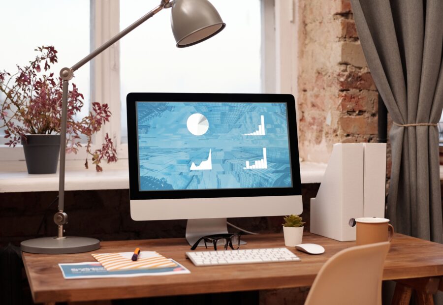 Modern home workspace with a desktop computer and lamp