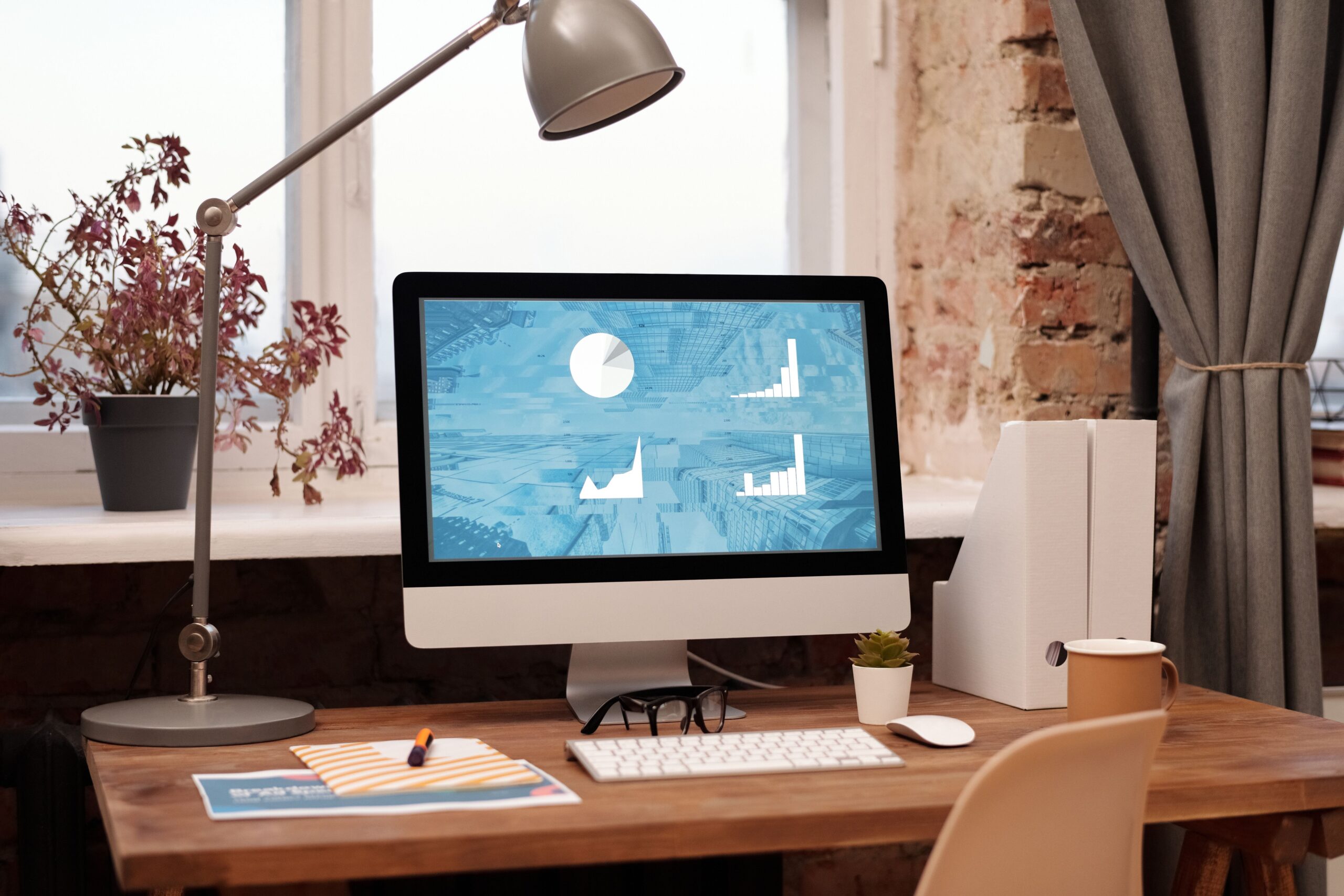 Modern home workspace with a desktop computer and lamp